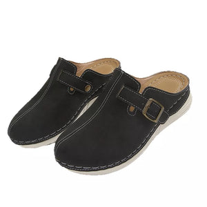 Black slip-on flats with buckle detail and contrast stitching