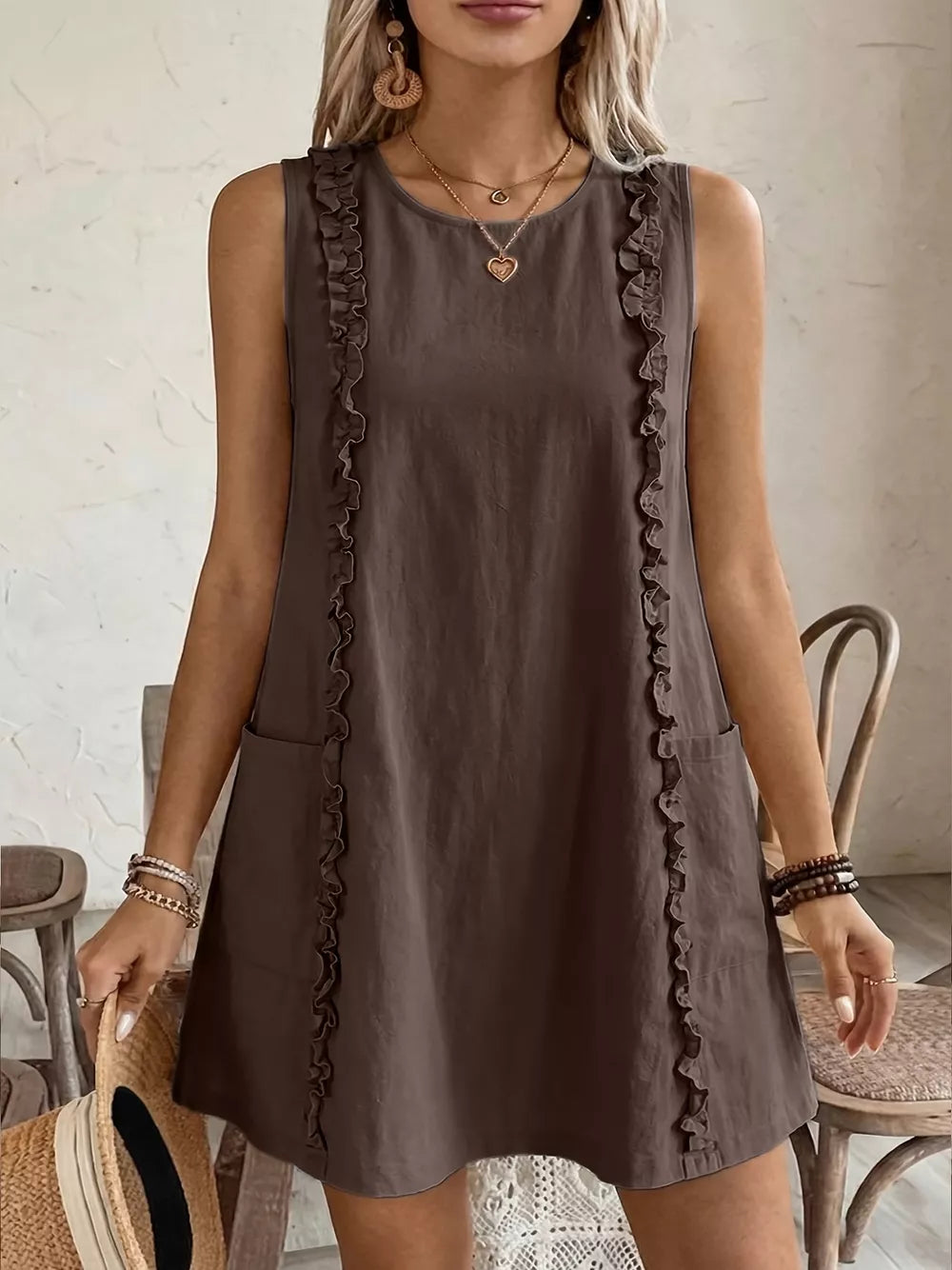 Coffee brown sleeveless dress with frill trim and pockets.