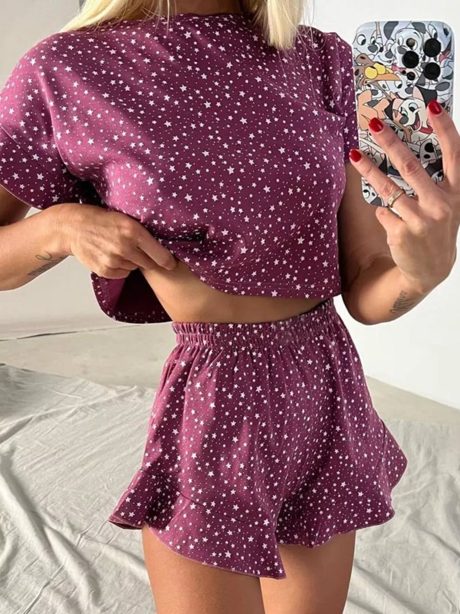 Purple star-print pajama set with ruffled shorts and crop top.
