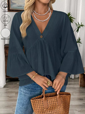 Navy blue cotton V-neck blouse with bell sleeves and a single button detail.