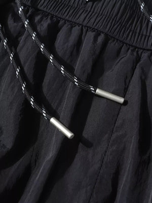 Black wide-leg cargo pants with drawstring and metal tips, elastic waistband.