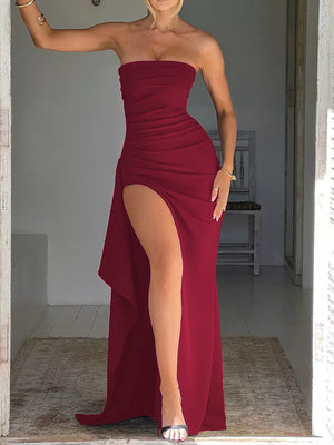 Burgundy strapless maxi dress with ruching and a high slit.