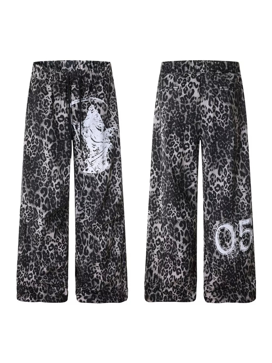 Leopard print cotton sweatpants with drawstring waist and wide legs, featuring graphic print details.