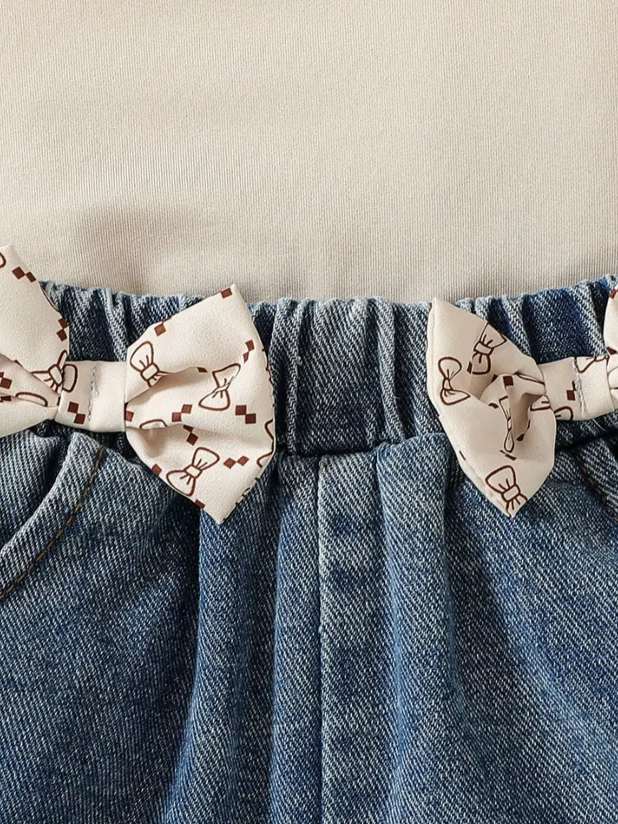 Baby denim shorts with bow print trim and elastic waistband.