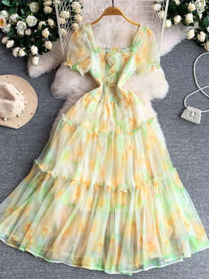 Floral tiered midi dress in sherbet with smocked bodice and puff sleeves.