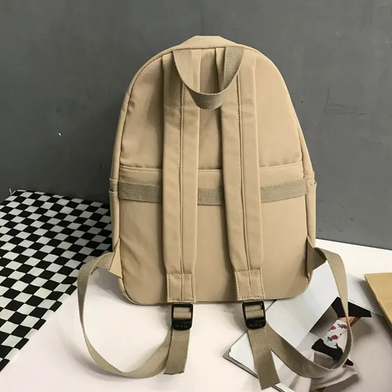 Khaki canvas backpack with dual pockets and adjustable straps