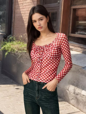 Red gingham tie-front long sleeve maternity shirt with a square neckline.