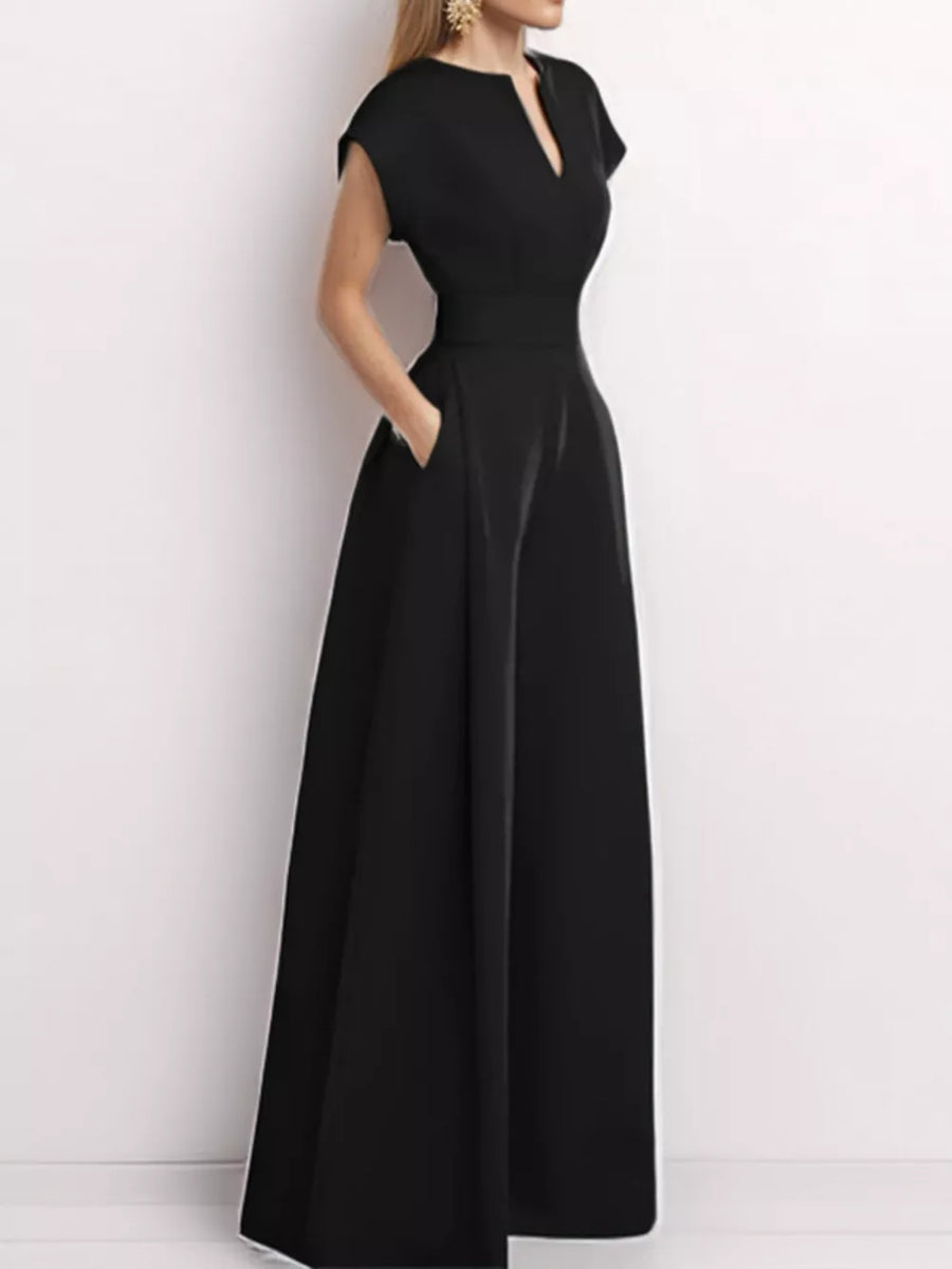 Black wide-leg romper with notched neckline, cap sleeves, and pockets.