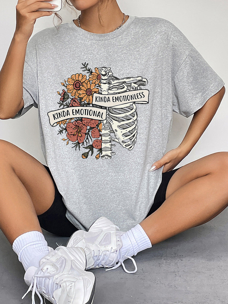 Grey graphic t-shirt with skeleton, flowers, and text "Kinda Emotional Kinda Emotionless