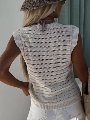 Beige open-stitch sleeveless knit tank top with horizontal stripe pattern and tie detail at neck.