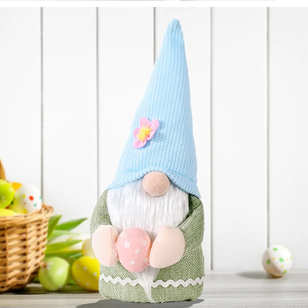 Bunny ear gnome decoration in green with pink Easter egg and blue knit hat with flower accent.