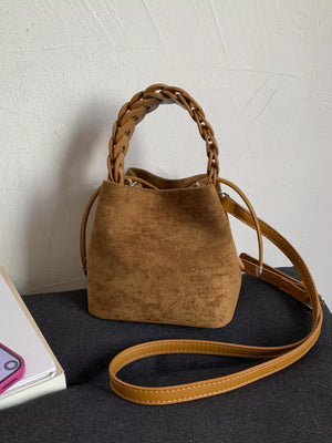 Brown suede mini crossbody bag with braided top handle and adjustable strap