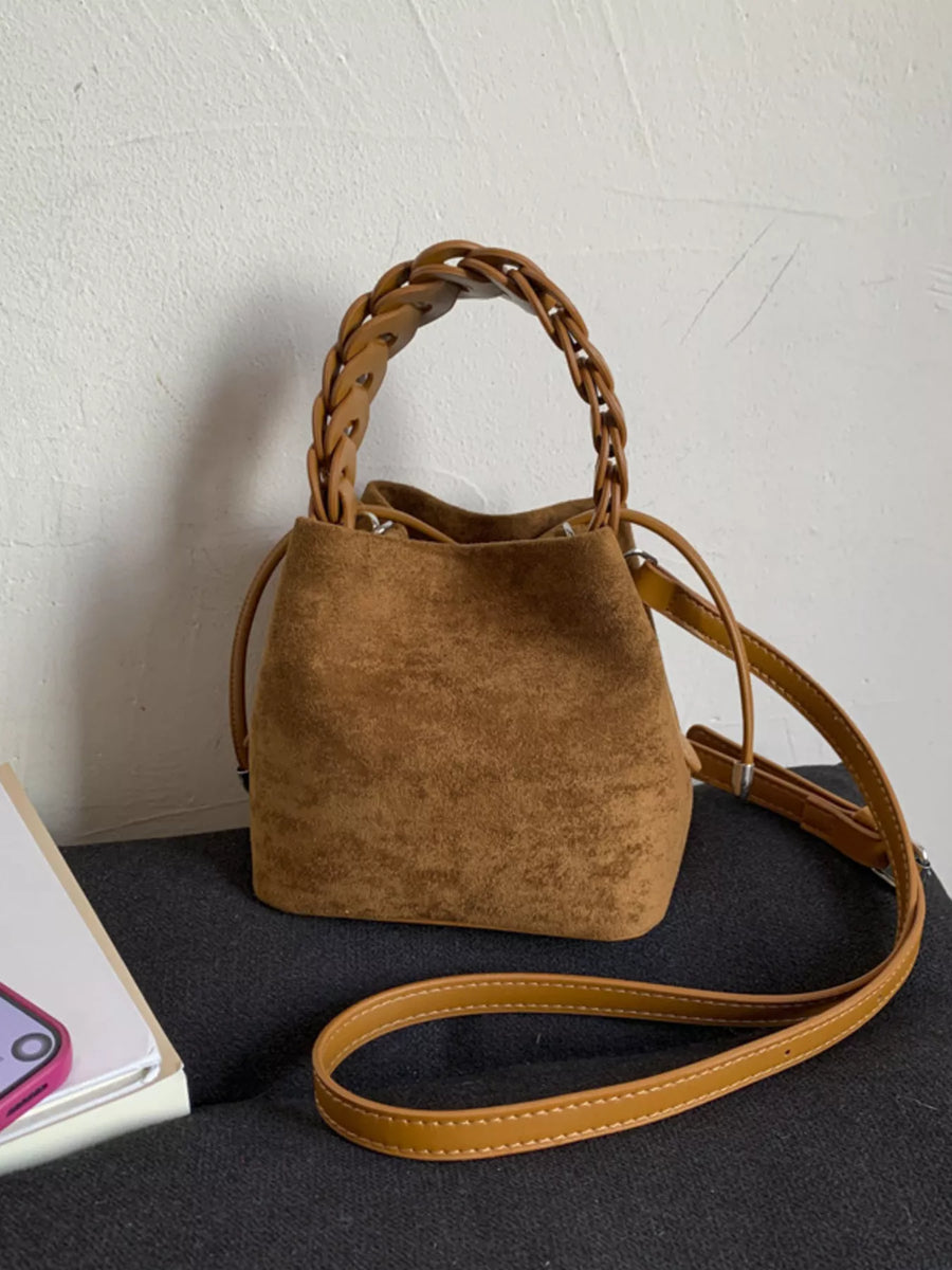 Brown suede mini crossbody bag with braided top handle and adjustable strap