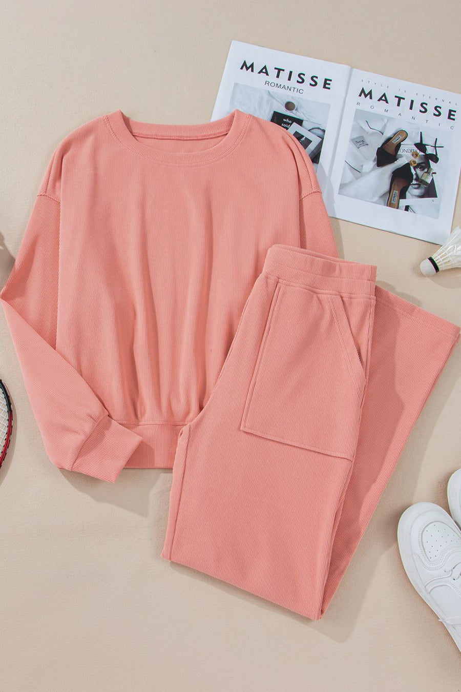 Pink ribbed crewneck sweatshirt with long sleeves and matching pants with pocket
