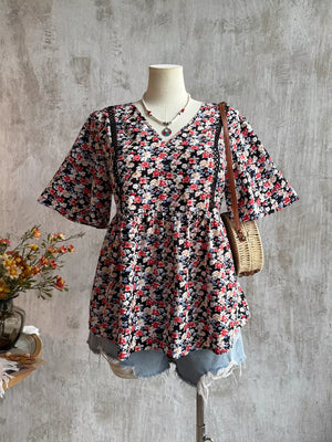 Black floral V-neck blouse with lace trim and flutter sleeves.