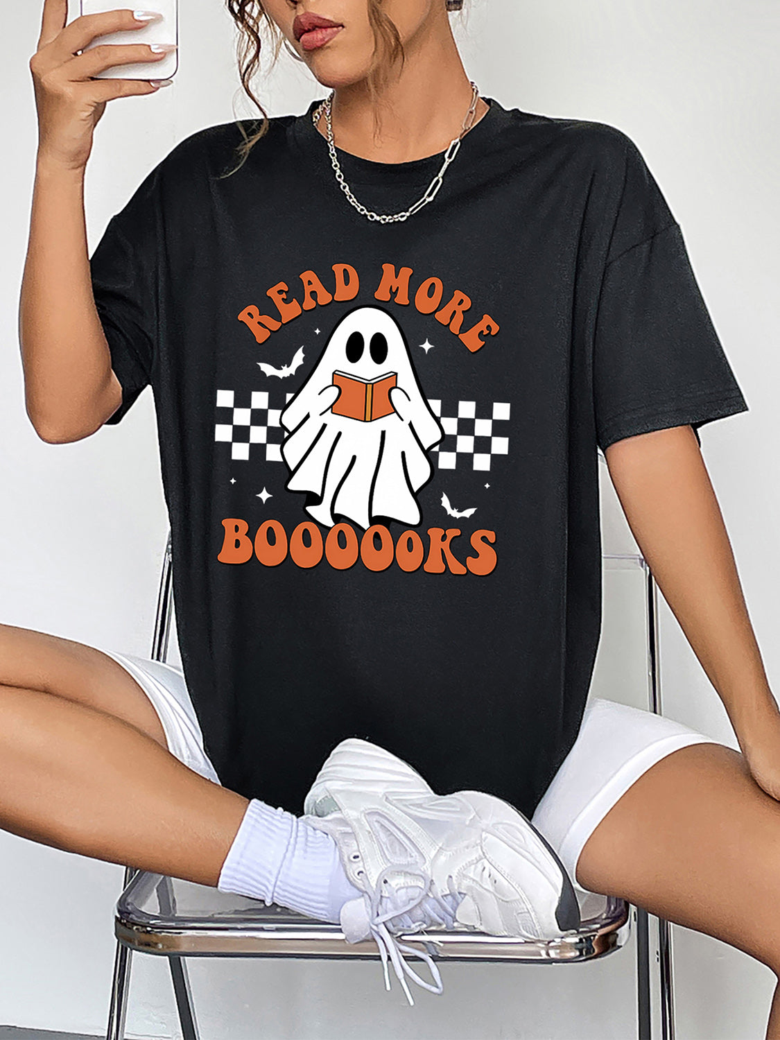 Black graphic t-shirt with a ghost reading a book and "Read More Boooooks" text.