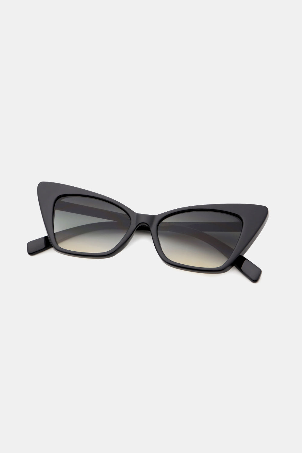 Black acetate cat-eye sunglasses with sharp angular frames and gradient lenses.