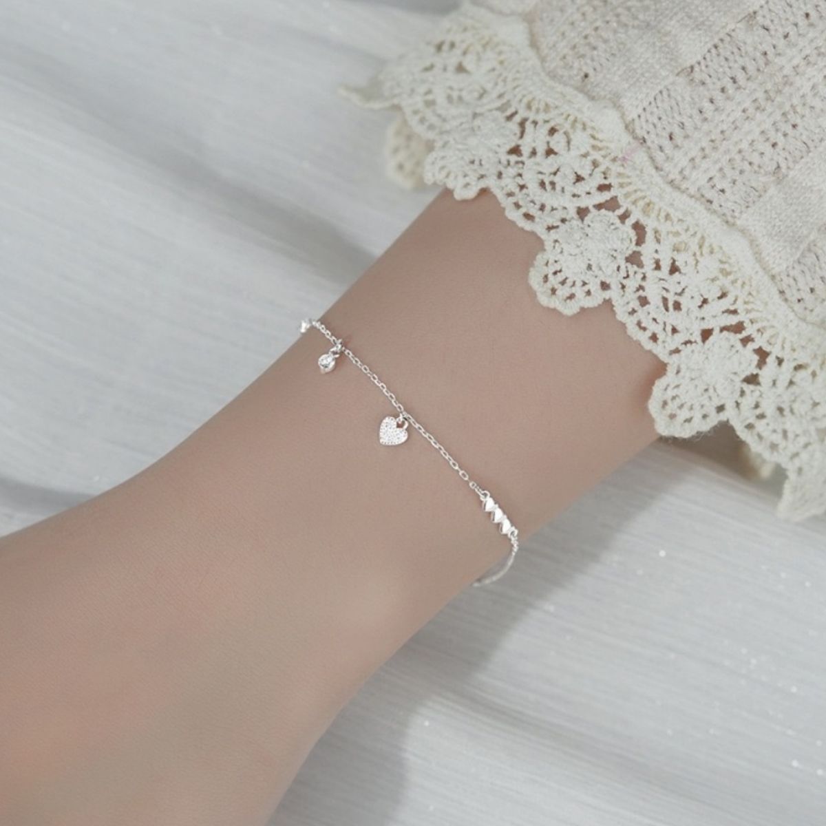 Silver sterling bracelet with pavé heart charm and delicate chain.