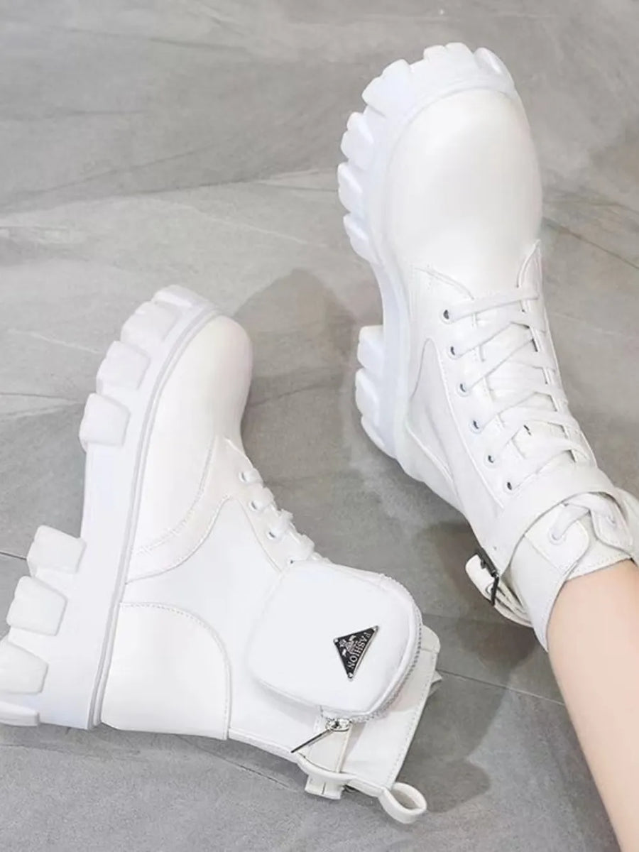 White utility pocket lug sole boots with lace-up front and buckle strap detail.