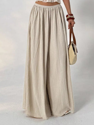 Textured wide-leg maternity pants in beige cotton with a gathered elastic waist.