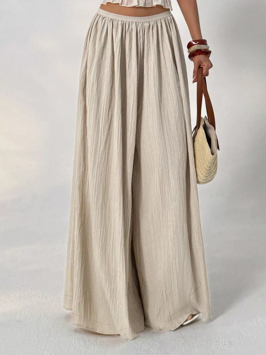 Textured wide-leg maternity pants in beige cotton with a gathered elastic waist.