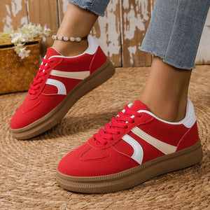 Chic lace-up contrast sneakers in deep red with cream and white accents and a brown sole.