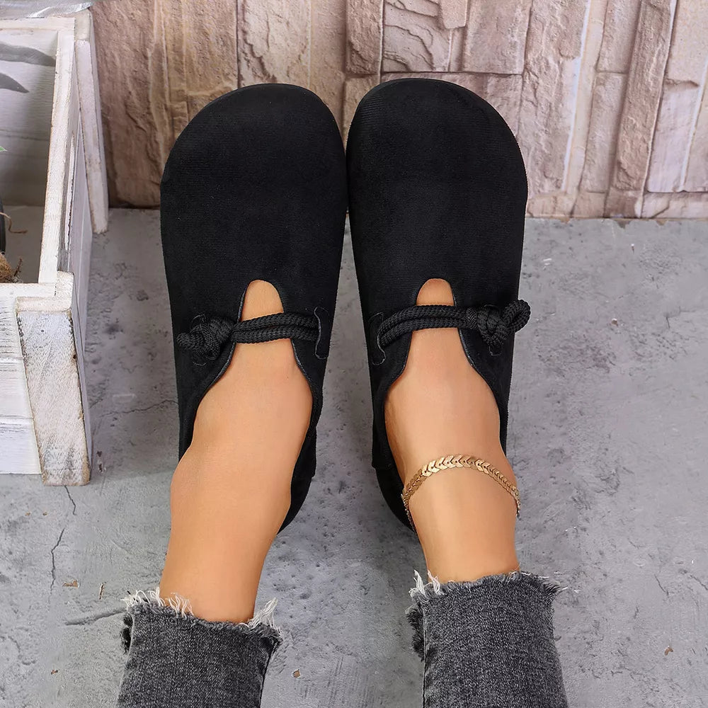 slip-ons in black featuring round toe and flat fit