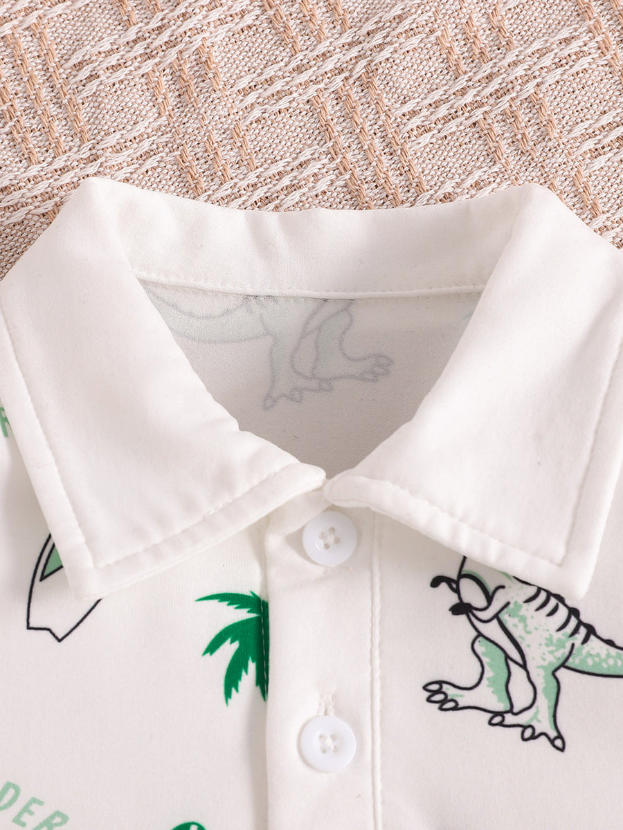 White baby polo shirt with dinosaur print and green palm trees, featuring a collar and button placket.