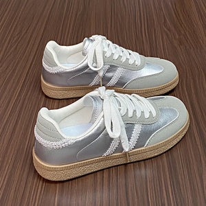 Retro panelled lace-up trainers in silver with white laces and decorative trim.