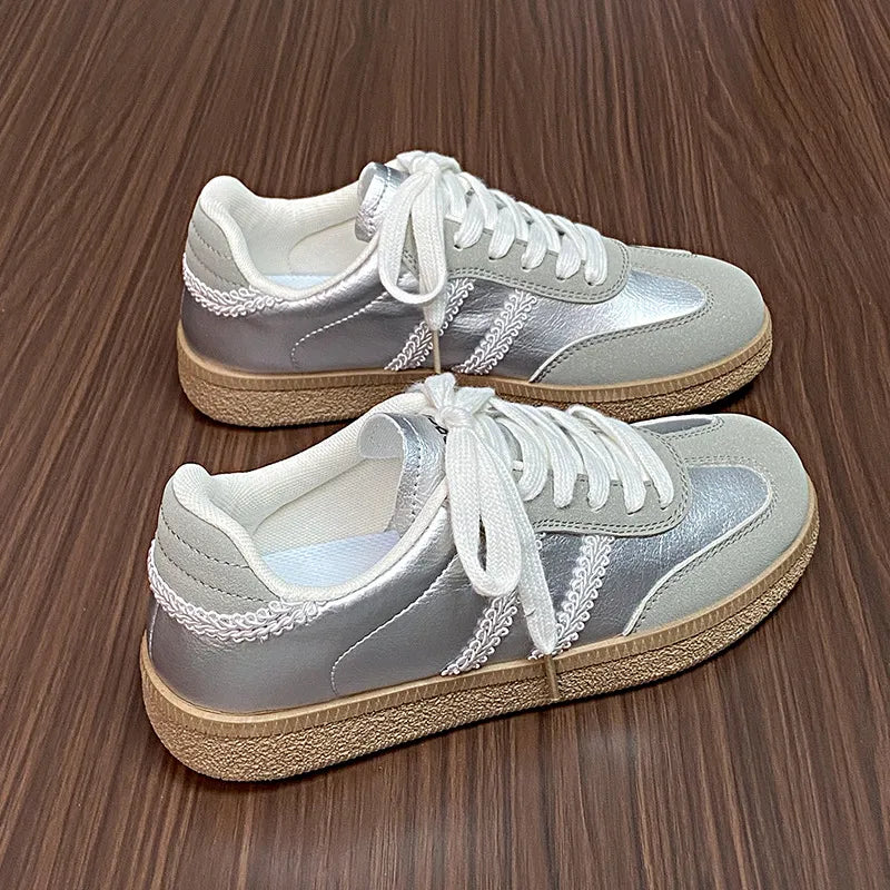 Retro panelled lace-up trainers in silver with white laces and decorative trim.