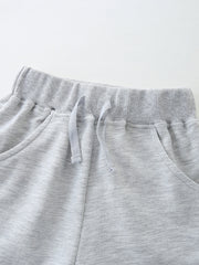 Light grey cotton shorts with elastic waistband and drawstring detail.