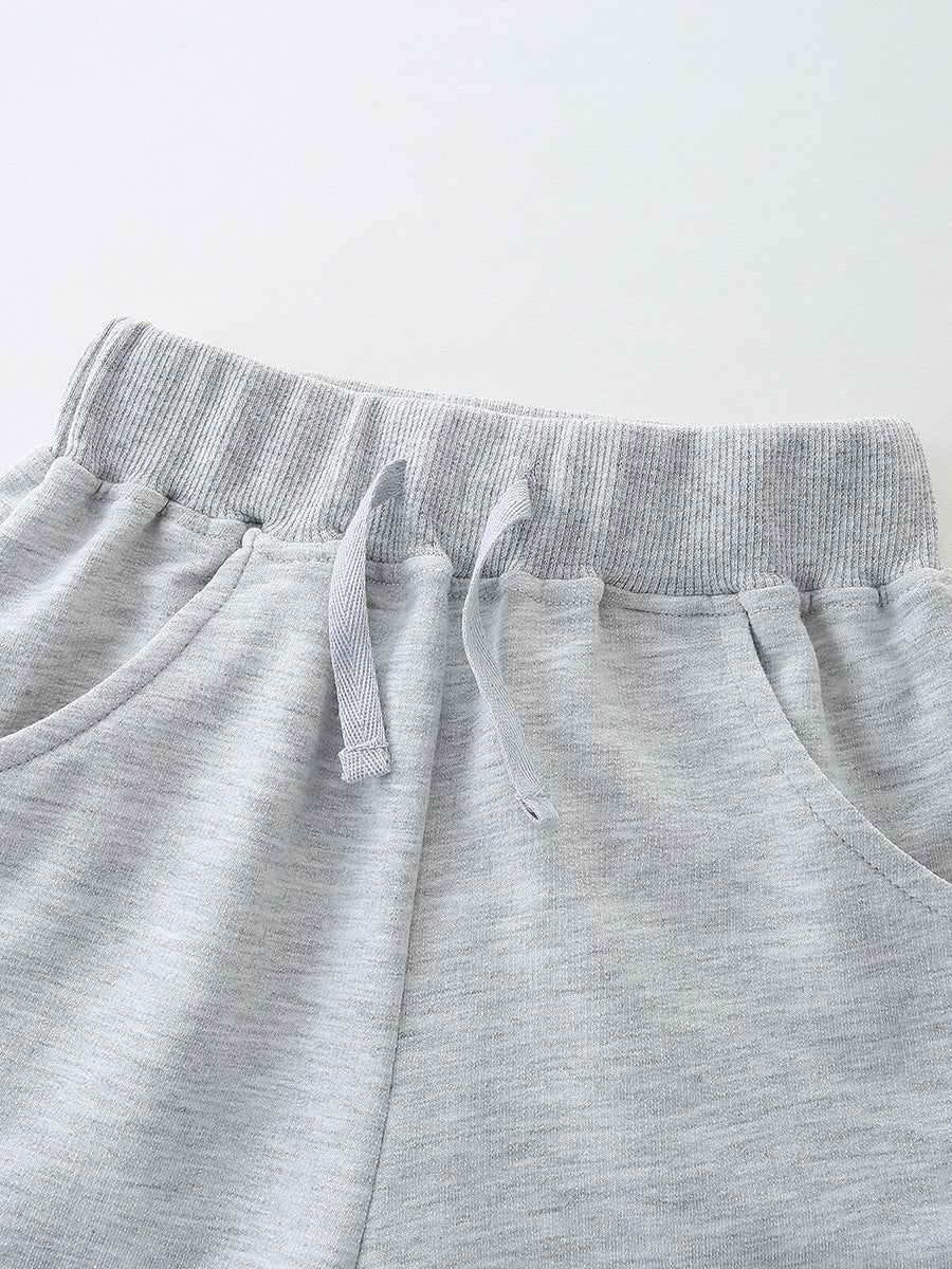 Light grey cotton shorts with elastic waistband and drawstring detail.