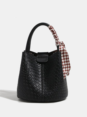 handbag in black featuring woven texture and bucket fit
