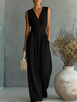 Black sleeveless V-neck wide-leg jumpsuit with a wrap waist and pockets