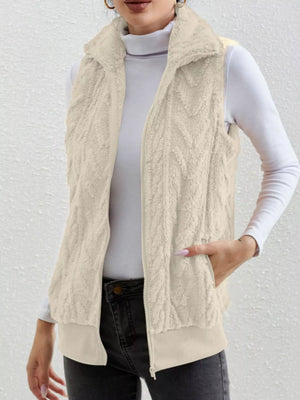Off-white faux fur zip-up vest with a textured pattern and ribbed hem.