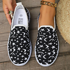 Black knit slip-on sneakers with white celestial pattern.
