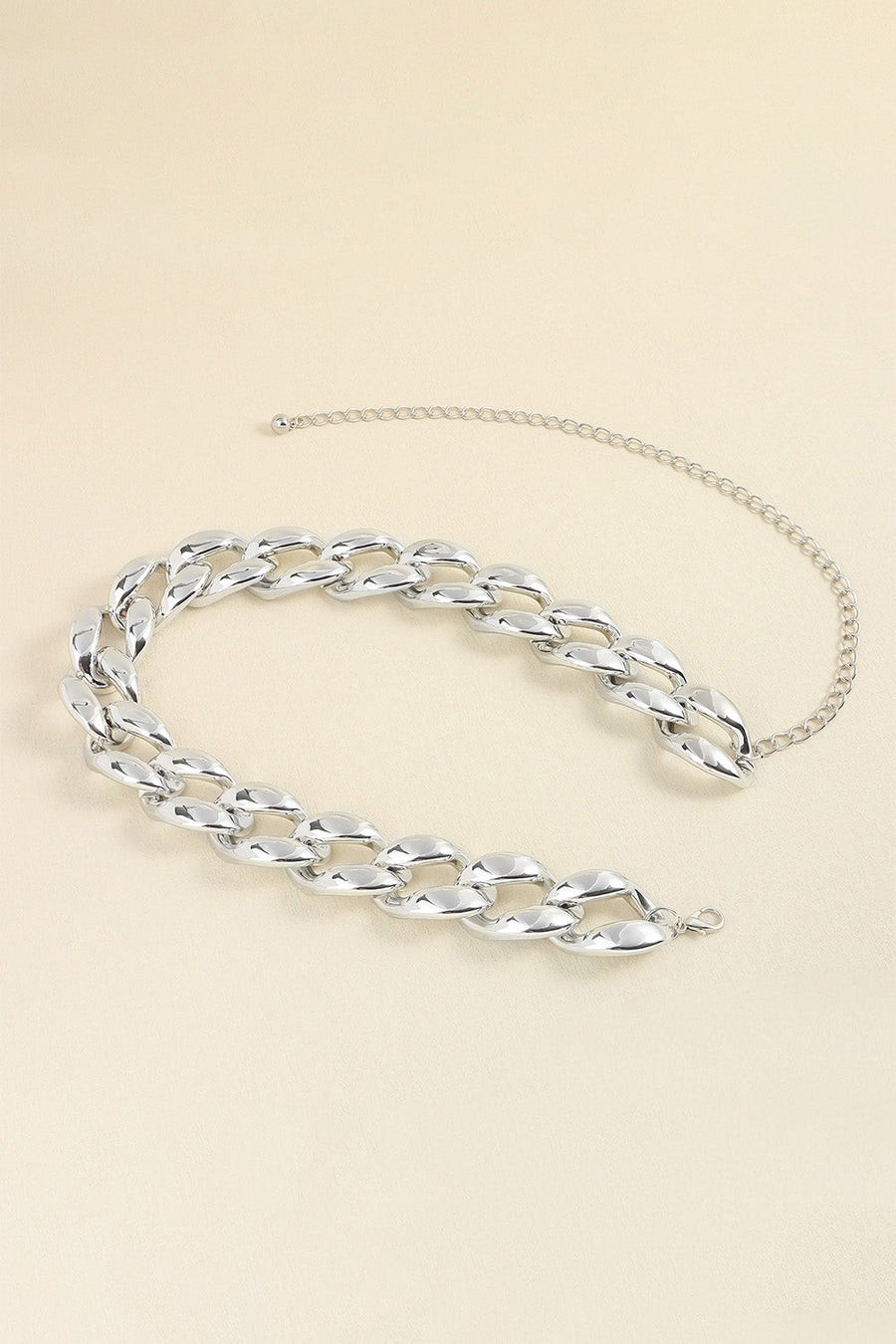 Silver sculptural chain belt with acrylic links and a delicate extender chain.
