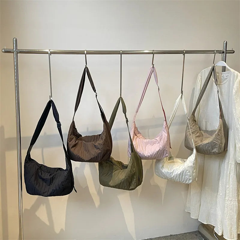 Quilted crescent shoulder bags in black, coffee brown, olive, pink, beige, and white.