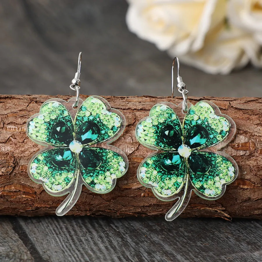 Emerald clover earrings with dark green gemstones and acrylic material.
