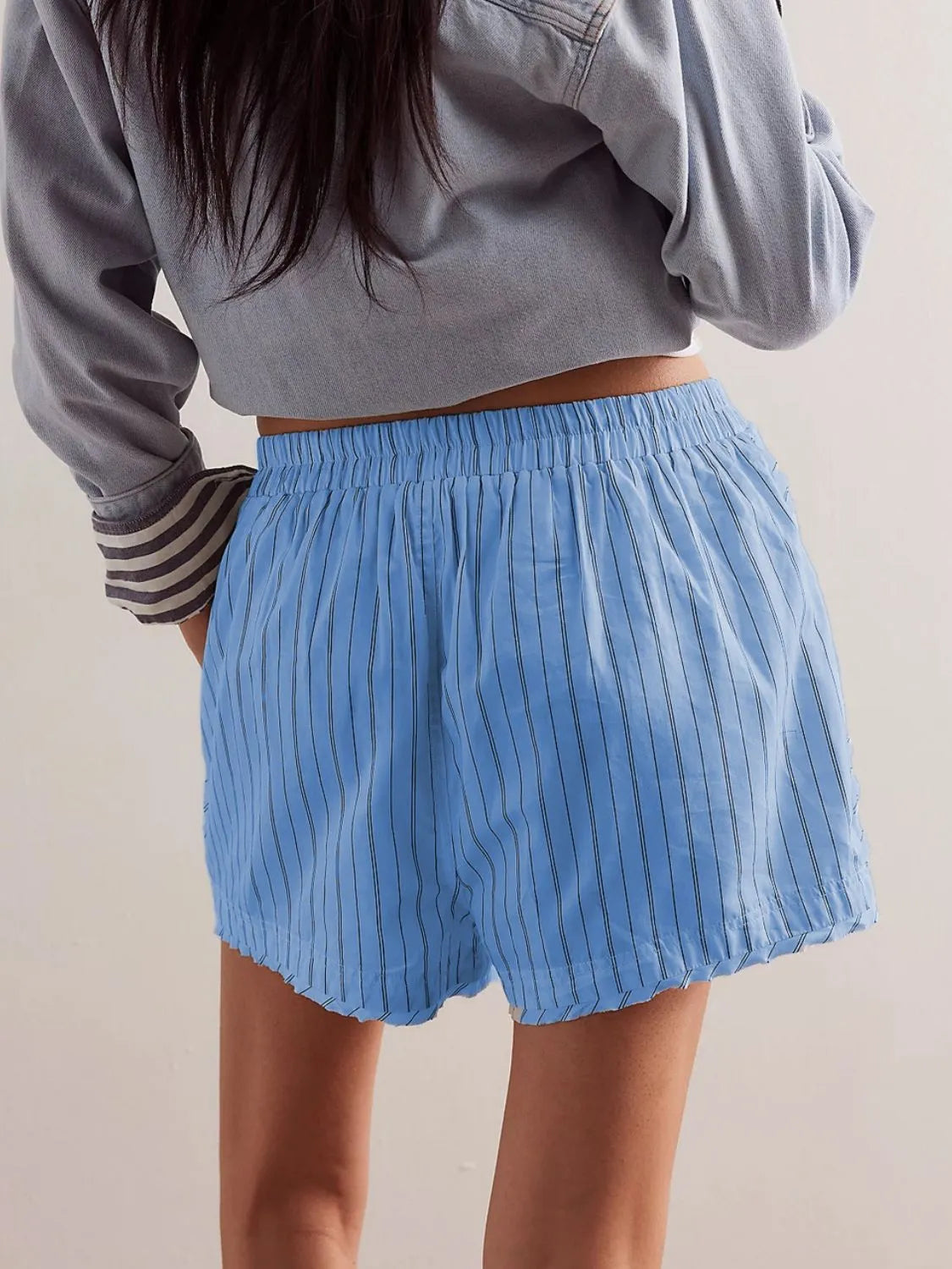 Light blue pinstripe boxer shorts with elastic waistband and raw hem