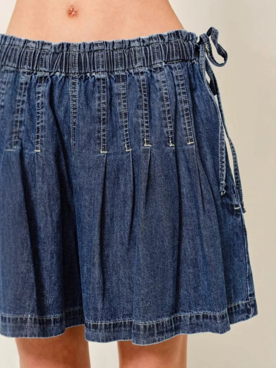Dark blue denim-effect shorts with ruched waist and tie detail.