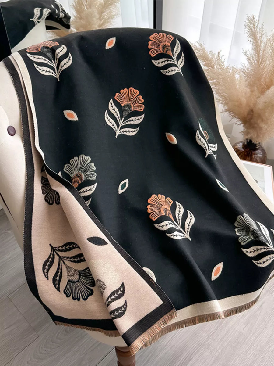 Black floral print fringed shawl with beige border and fringe detail.
