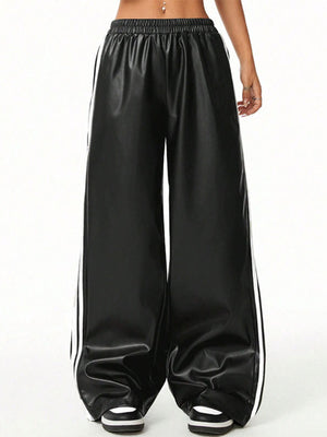 Black faux leather wide leg track pants with white side stripes and elastic waistband.