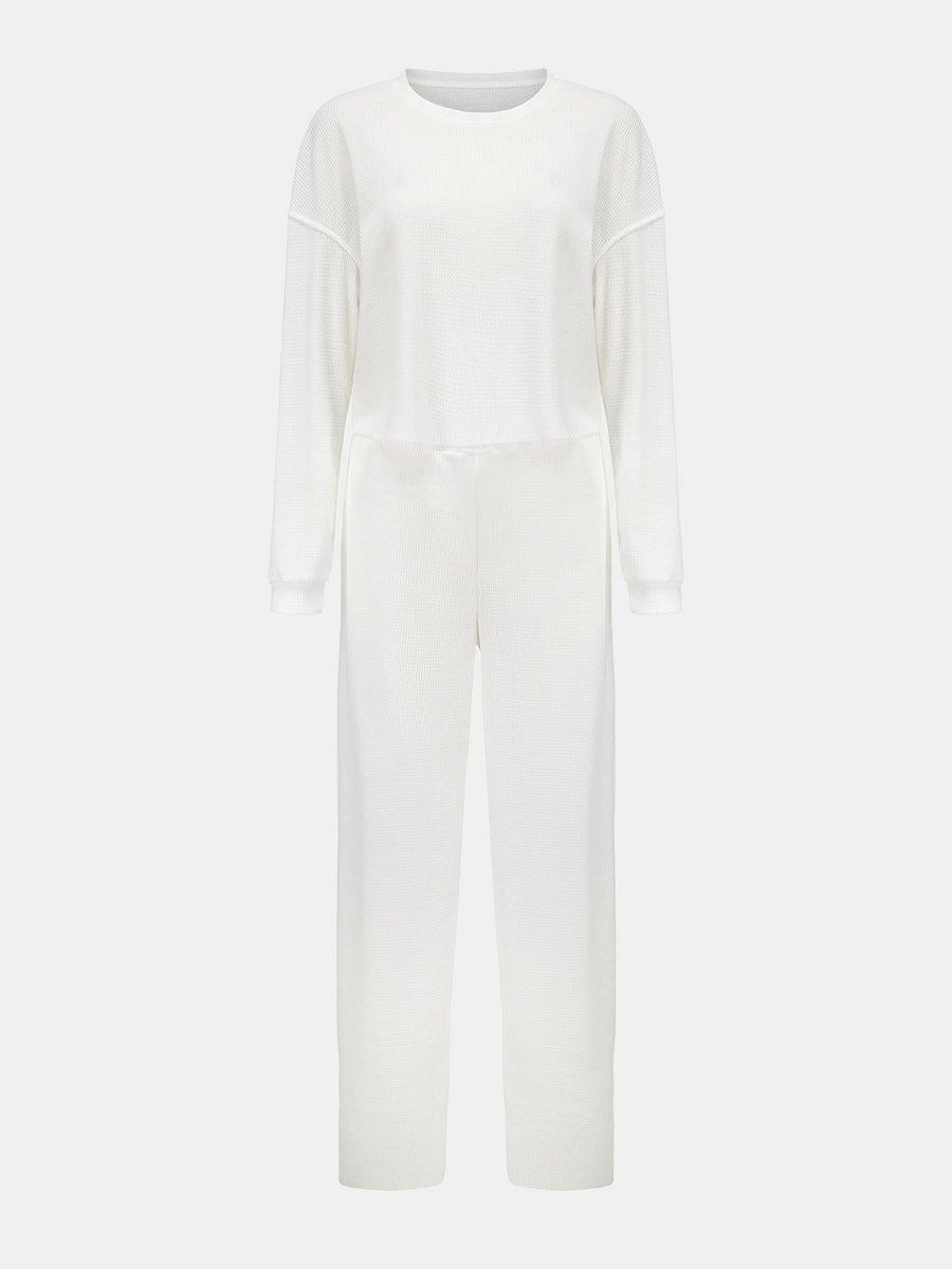 White waffle knit cropped lounge set with long sleeves and wide-leg pants.