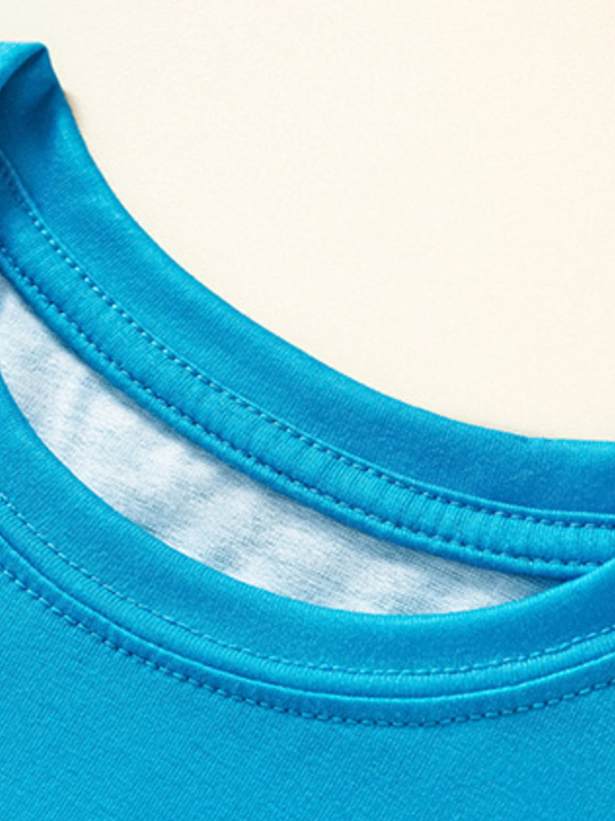 Toddler blue crew neck t-shirt with double-stitched neckline detail.