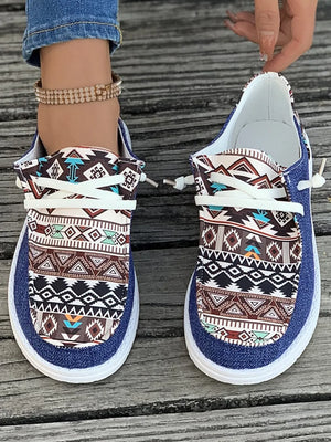 Aztec print canvas slip-on shoes in light indigo with white laces and a white sole.