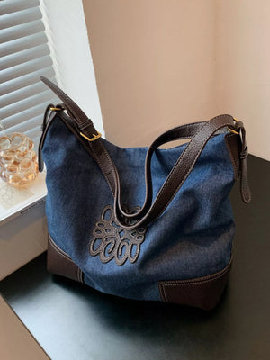 Blue denim shopper bag with brown trim and embroidered detail