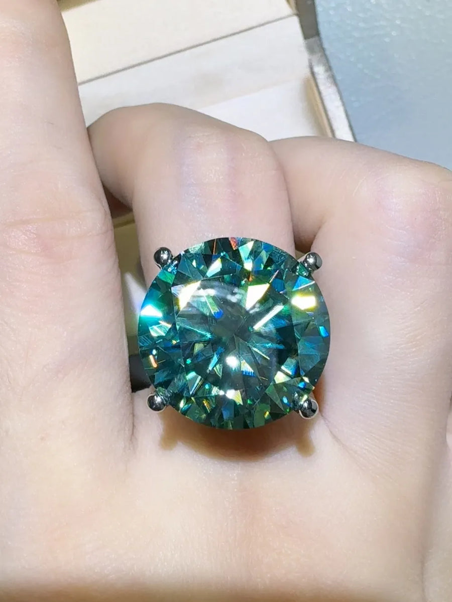 Prismatic teal statement ring with a large round-cut gemstone on a silver band.