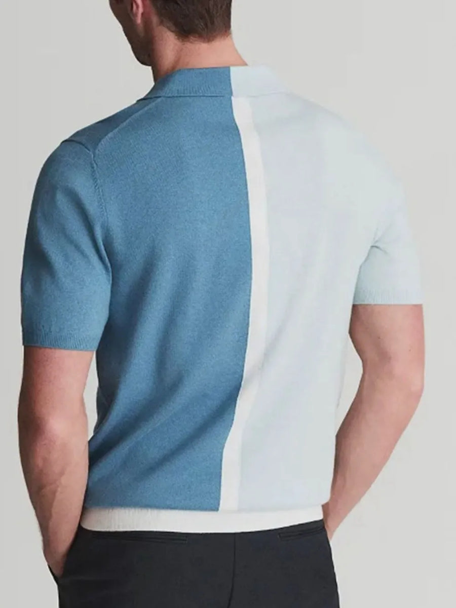 Colorblock knit polo shirt in cerulean with a contrast white placket and short sleeves.