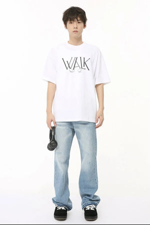 Baggy distressed denim jeans in medium wash with raw hem detail and a faded effect.